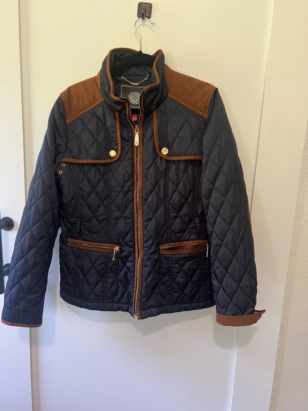 Vince Camuto, navy blue quilted jacket with brown suede trim.